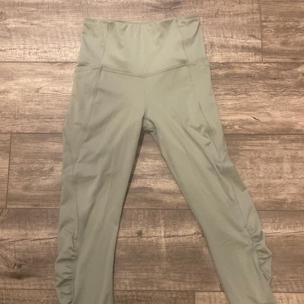 Sage green athletic leggings with pockets